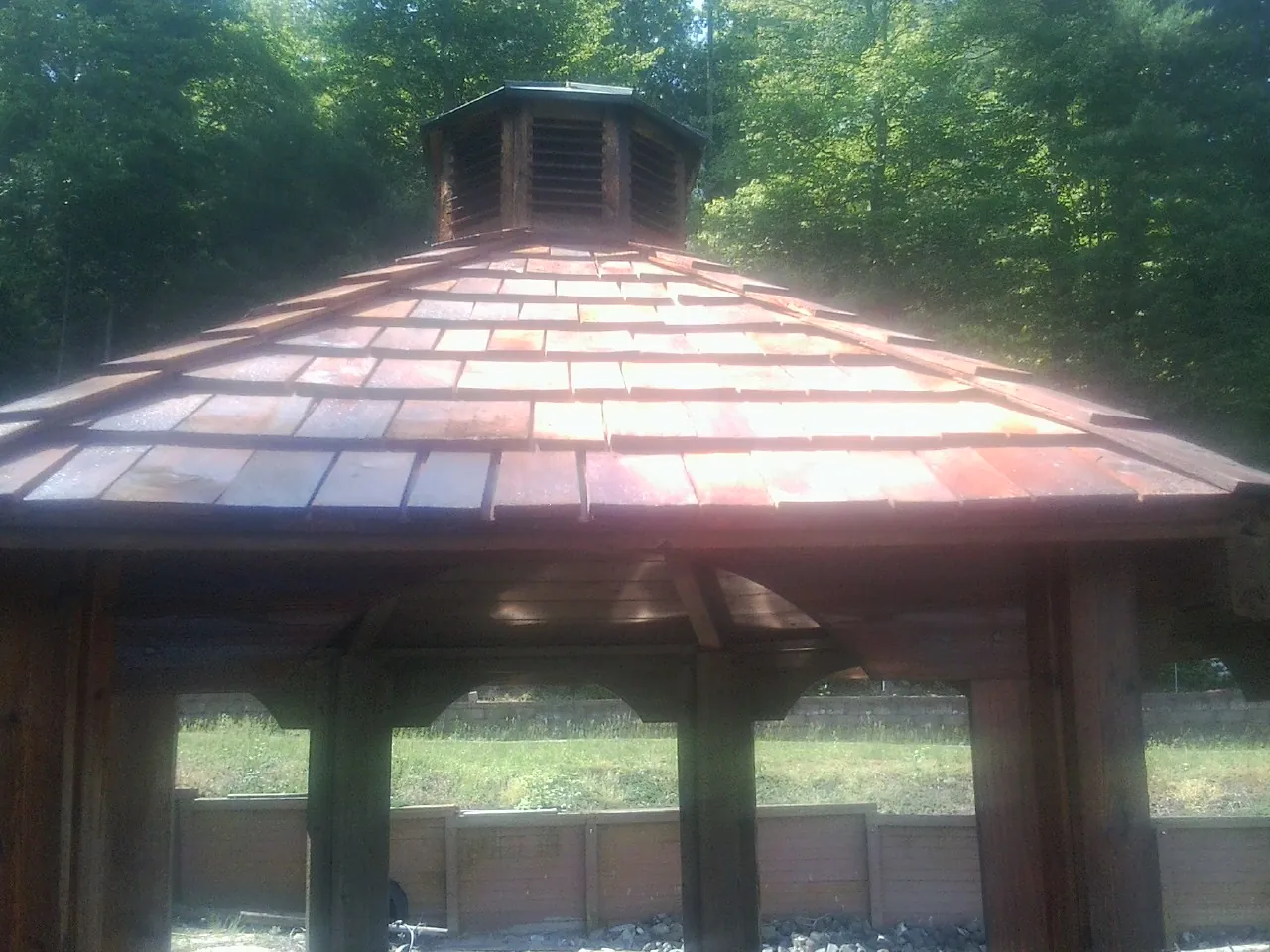 New cedar shake roof and cupola on a lakeside gazebo in Taftville